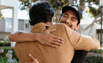 2 men hugging after talking about the road to recovery from addiction